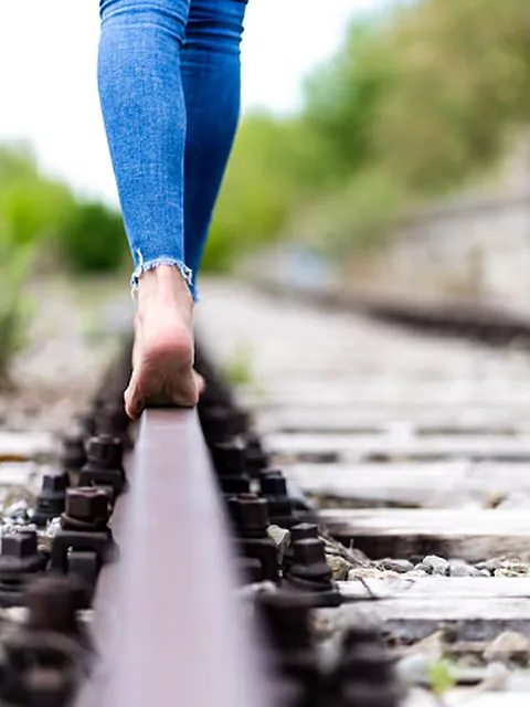 Bare feet balancing on a rail
